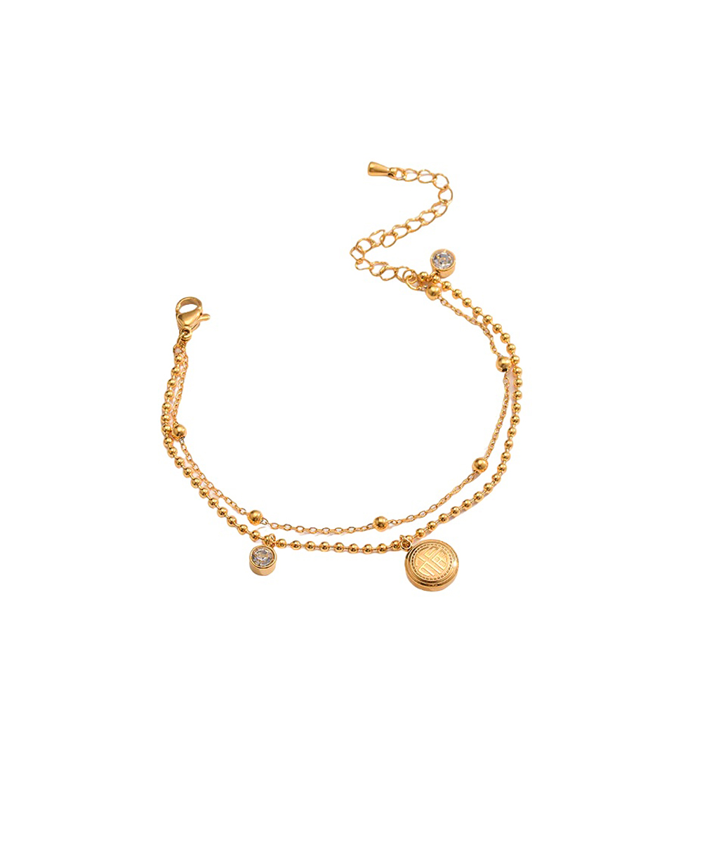 Διπλό βραχιόλι με ζιργκόν και κρεμαστό στοιχείο από ανοξείδωτο ατσάλι σε χρυσή απόχρωση